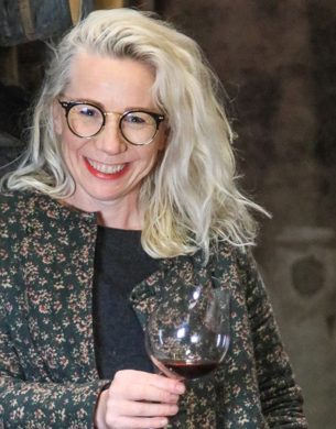 Helen Masters holding a glass of red wine