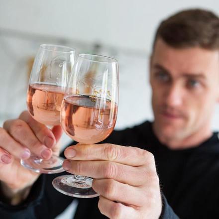 A man holding two glasses of a pink wine from Untitled Wines