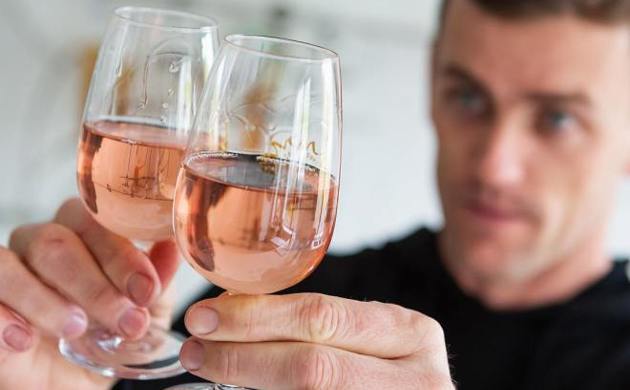 A man holding two glasses of a pink wine from Untitled Wines