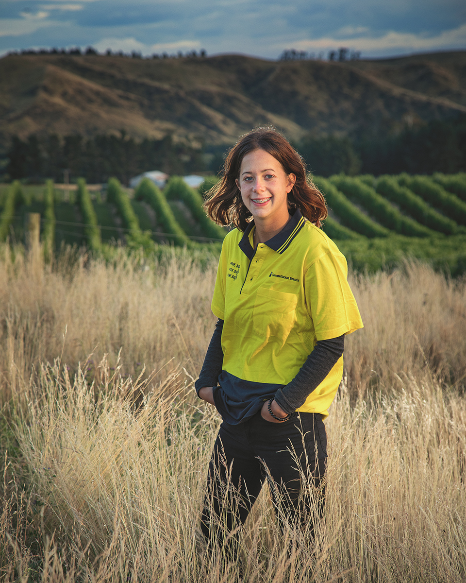 Katie Bruce with vineyard in the background