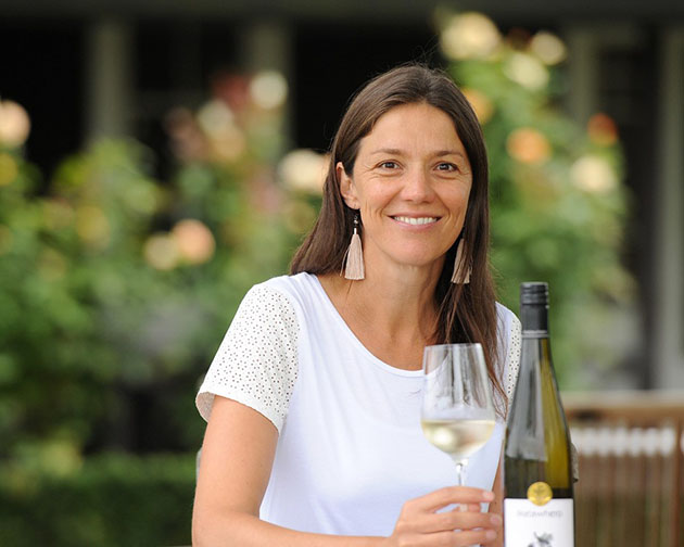 Kirsten Searle holding a glass of white wine