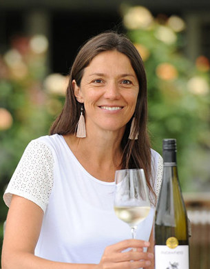 Kirsten Searle holding a glass of white wine