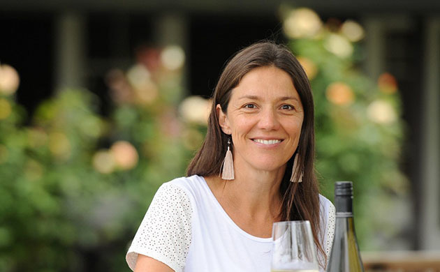 Kirsten Searle holding a glass of white wine