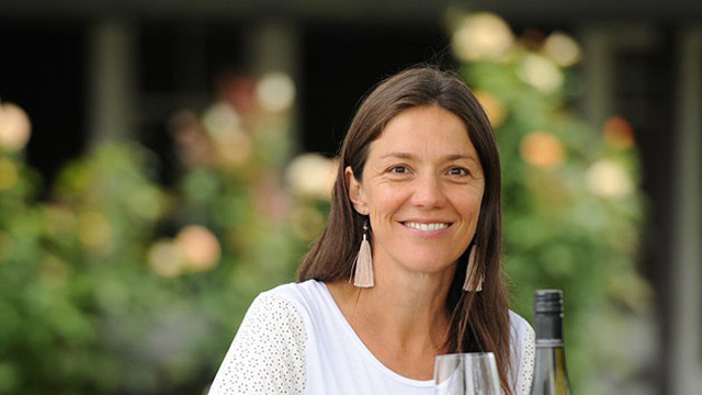 Kirsten Searle holding a glass of white wine