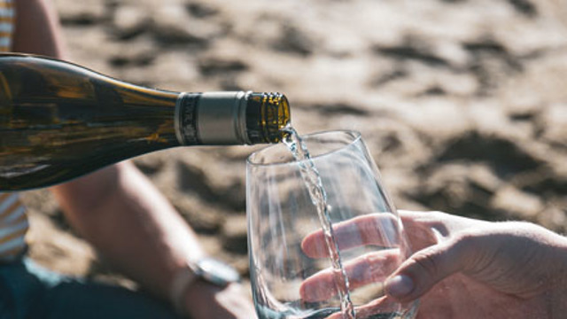 A glass being filled with Sauvignon Blanc
