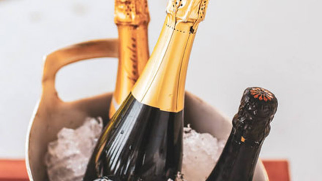 Sparkling wines in an ice bucket.
