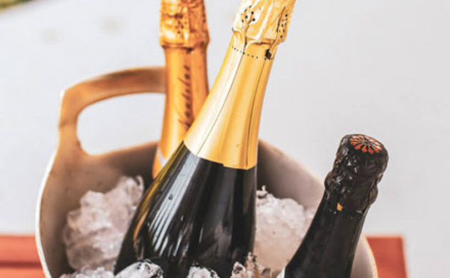 Sparkling wines in an ice bucket.