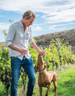 Dave Clouston in vineyard with dog