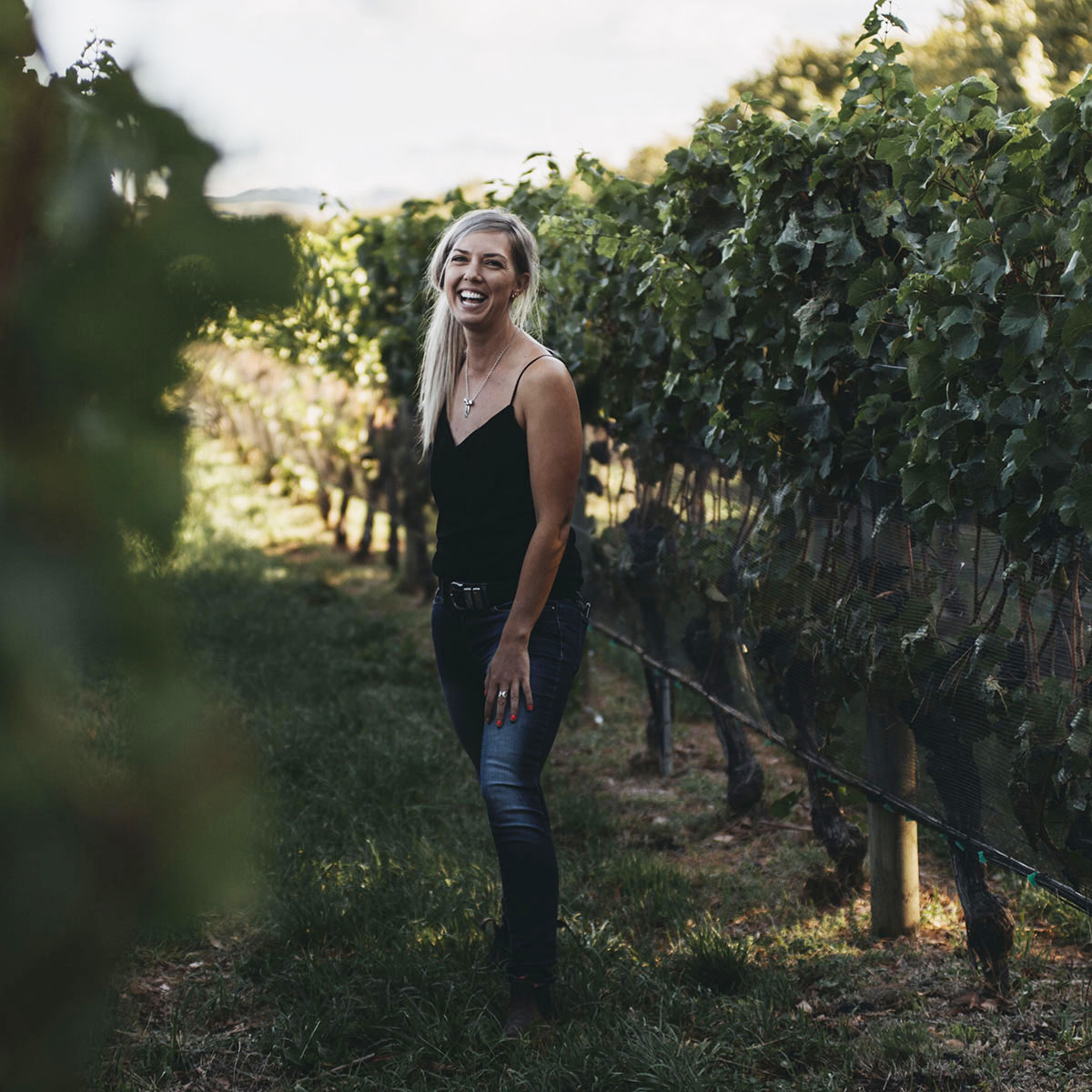 Alice Rule standing in vine rows