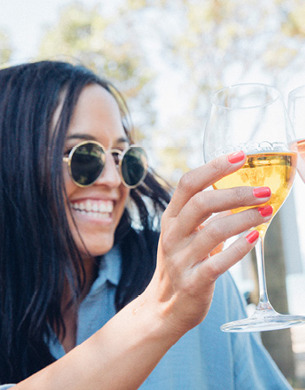 Woman raising wine glass