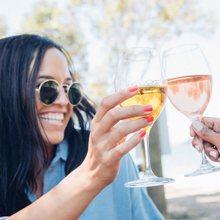 Woman raising wine glass