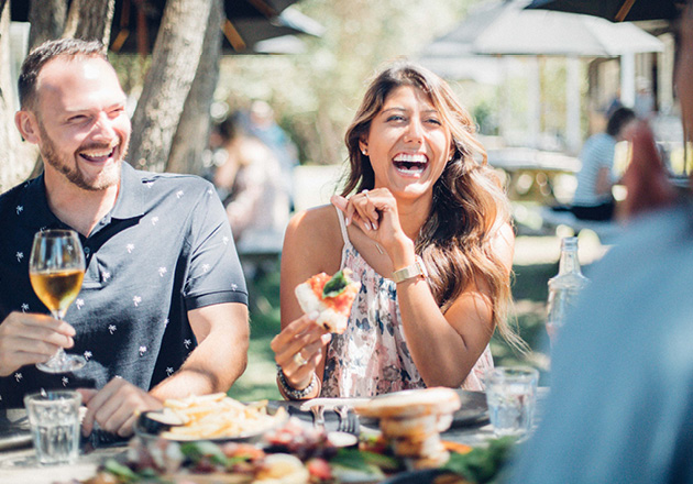 People laughing at a vineyard restaurant