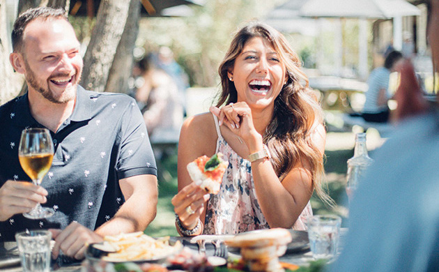 People laughing at a vineyard restaurant