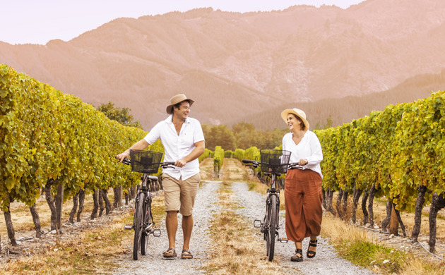 People walking through vineyard