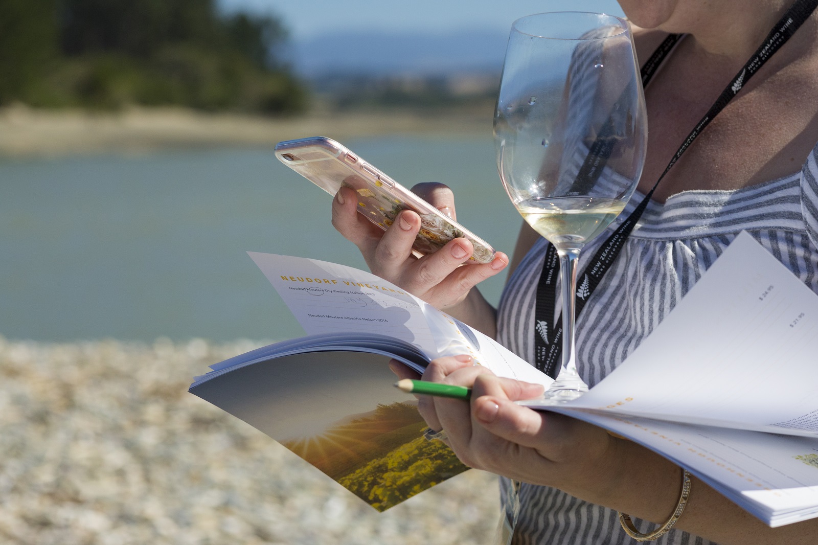 Woman holding wine glass and using mobile