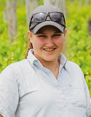 Rylee Adams standing in vineyard