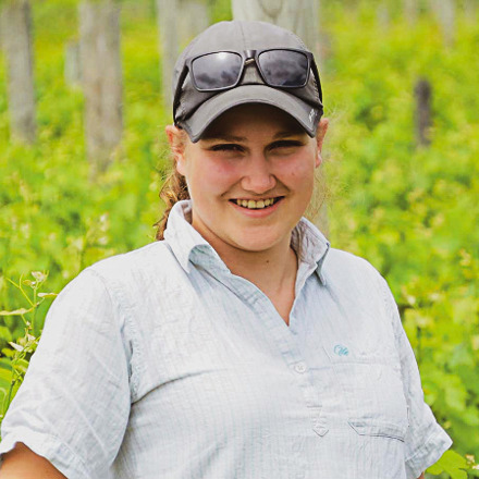 Rylee Adams standing in vineyard