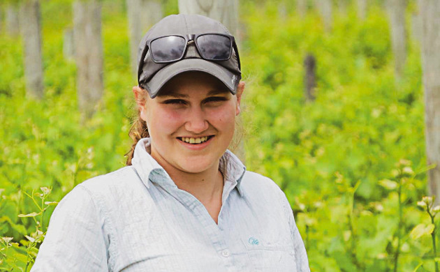 Rylee Adams standing in vineyard